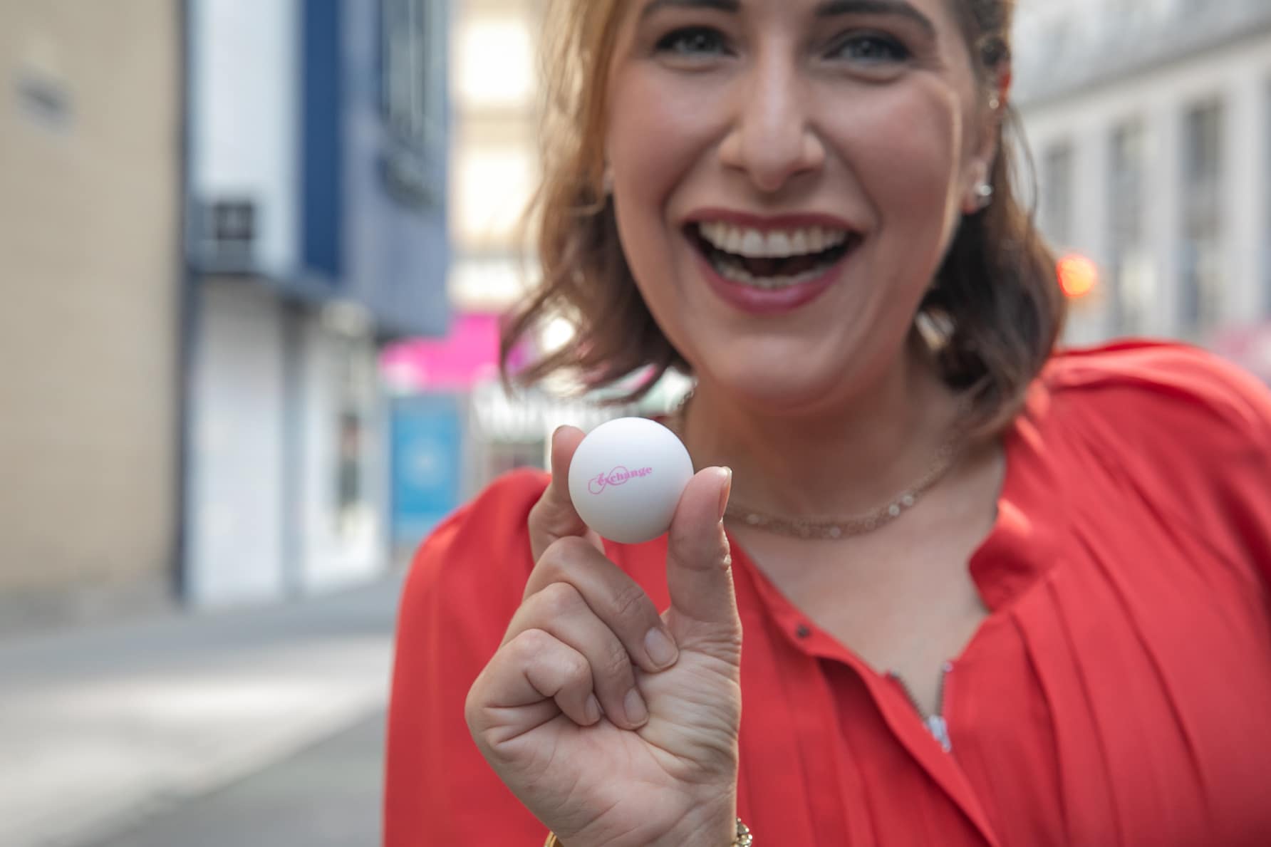 Woman smiling holding a white ball