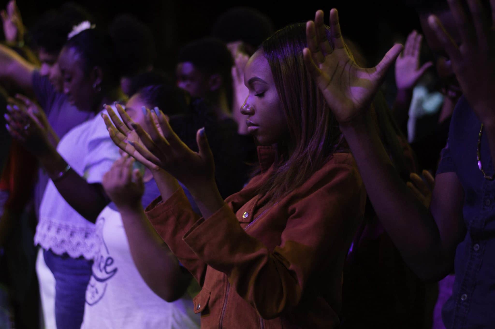 Girl teen in brown shirt praying