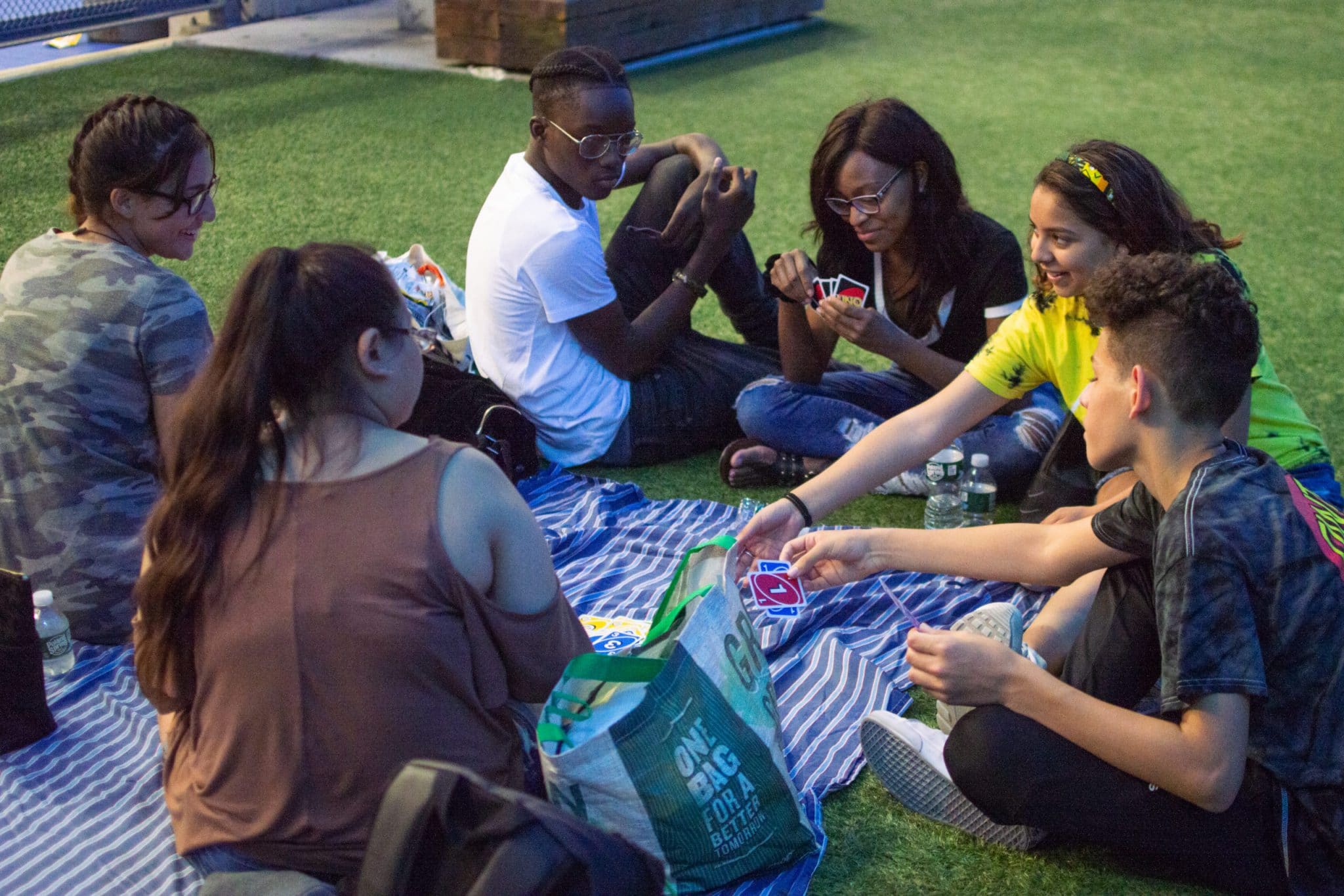 group of teens playing Uno - picnic