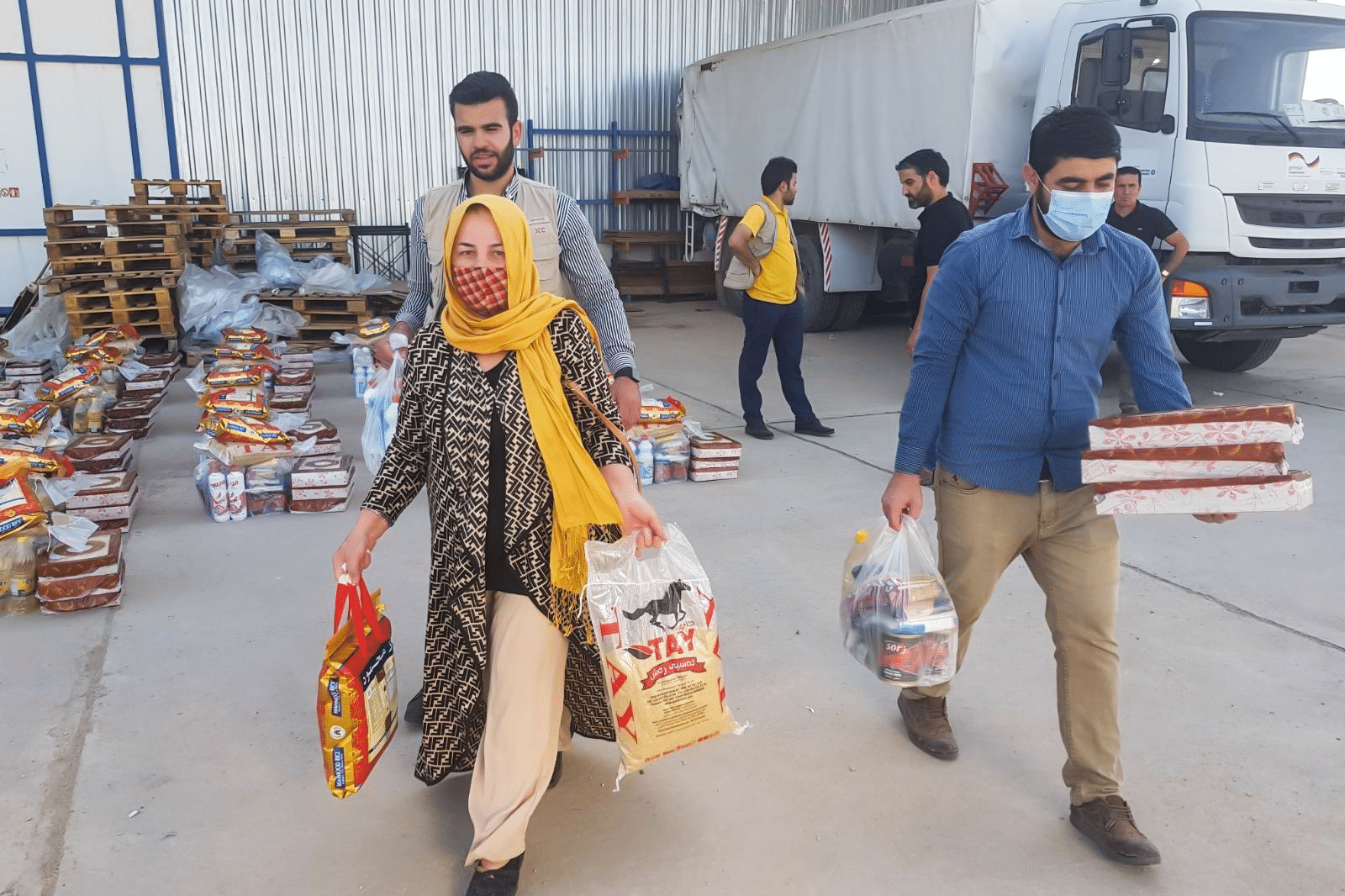 Men and woman carrying food package