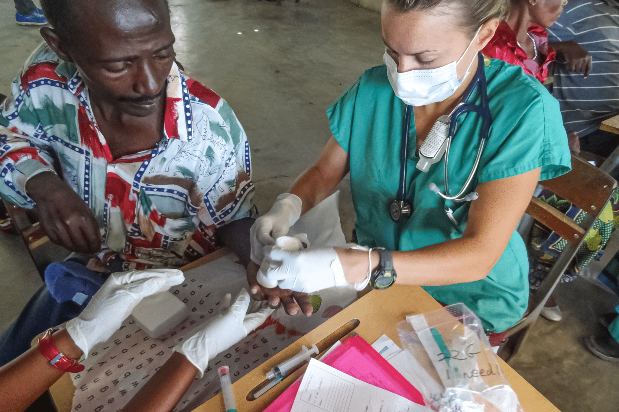 putting bandage on patient's left thumb