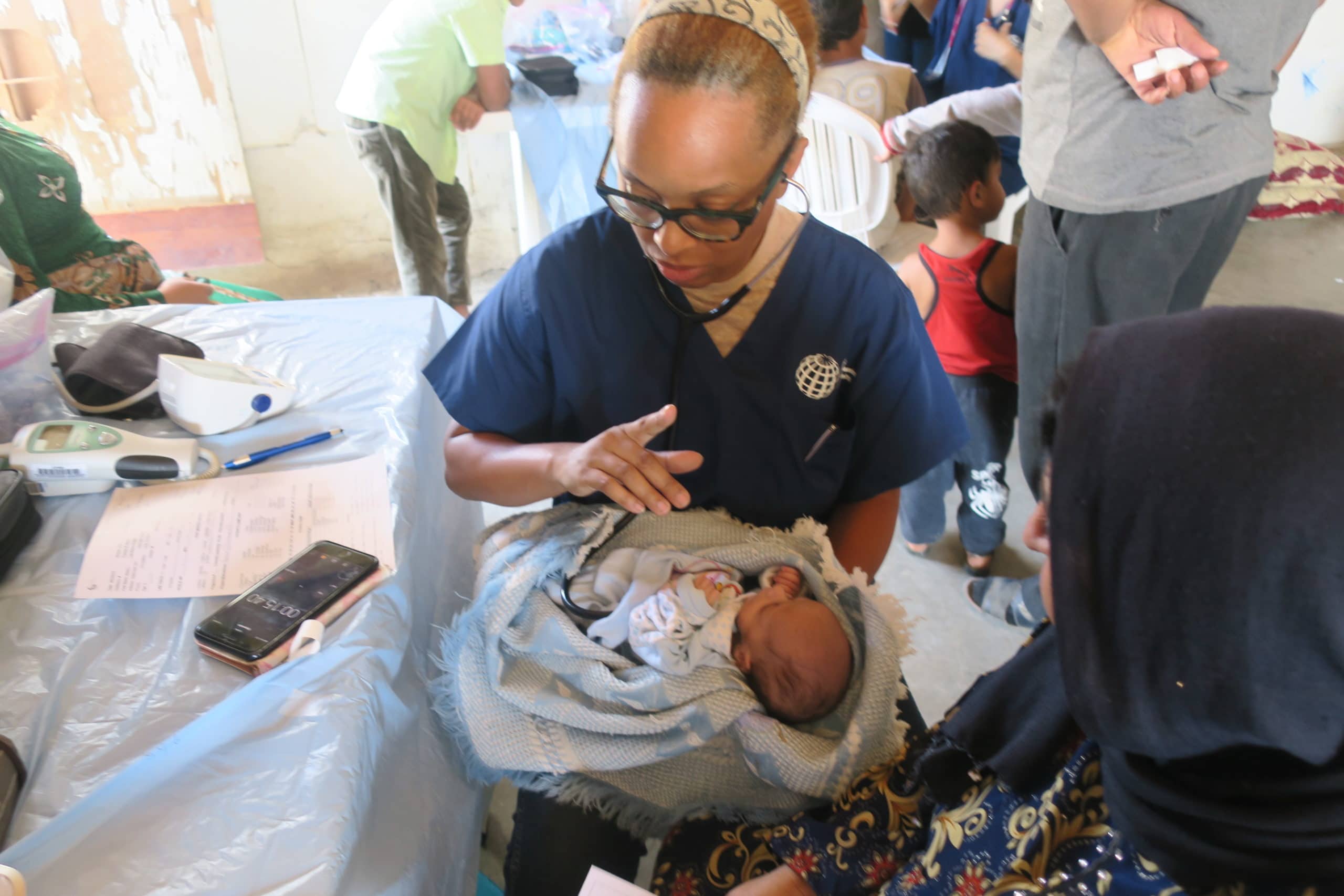 medical aid holding a baby