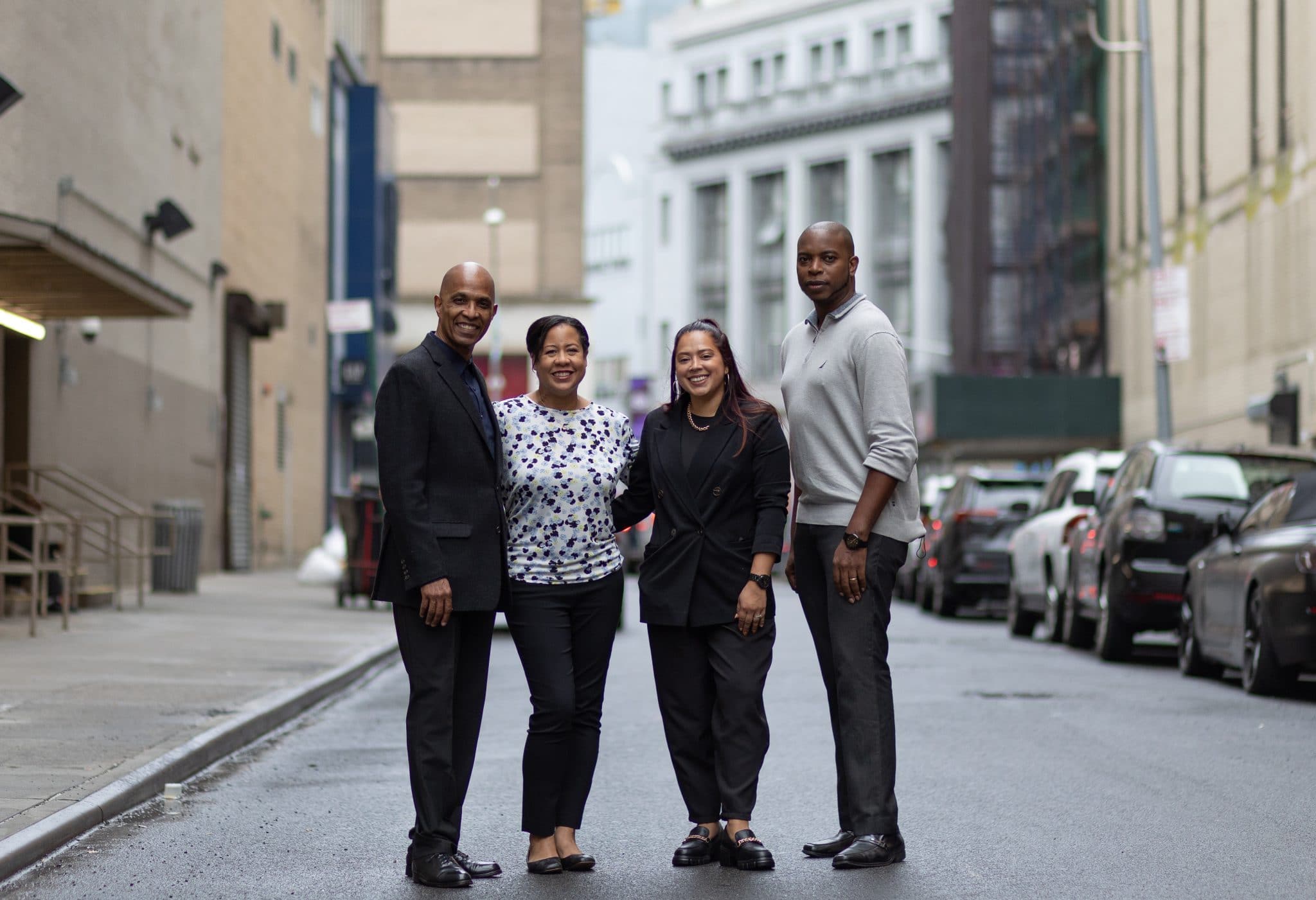 A beautiful shot of four people on the middle of the street of New York