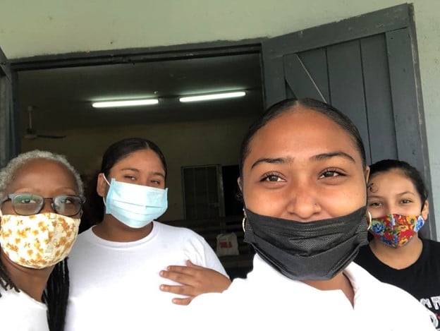 Four women wearing mask posed for groufie