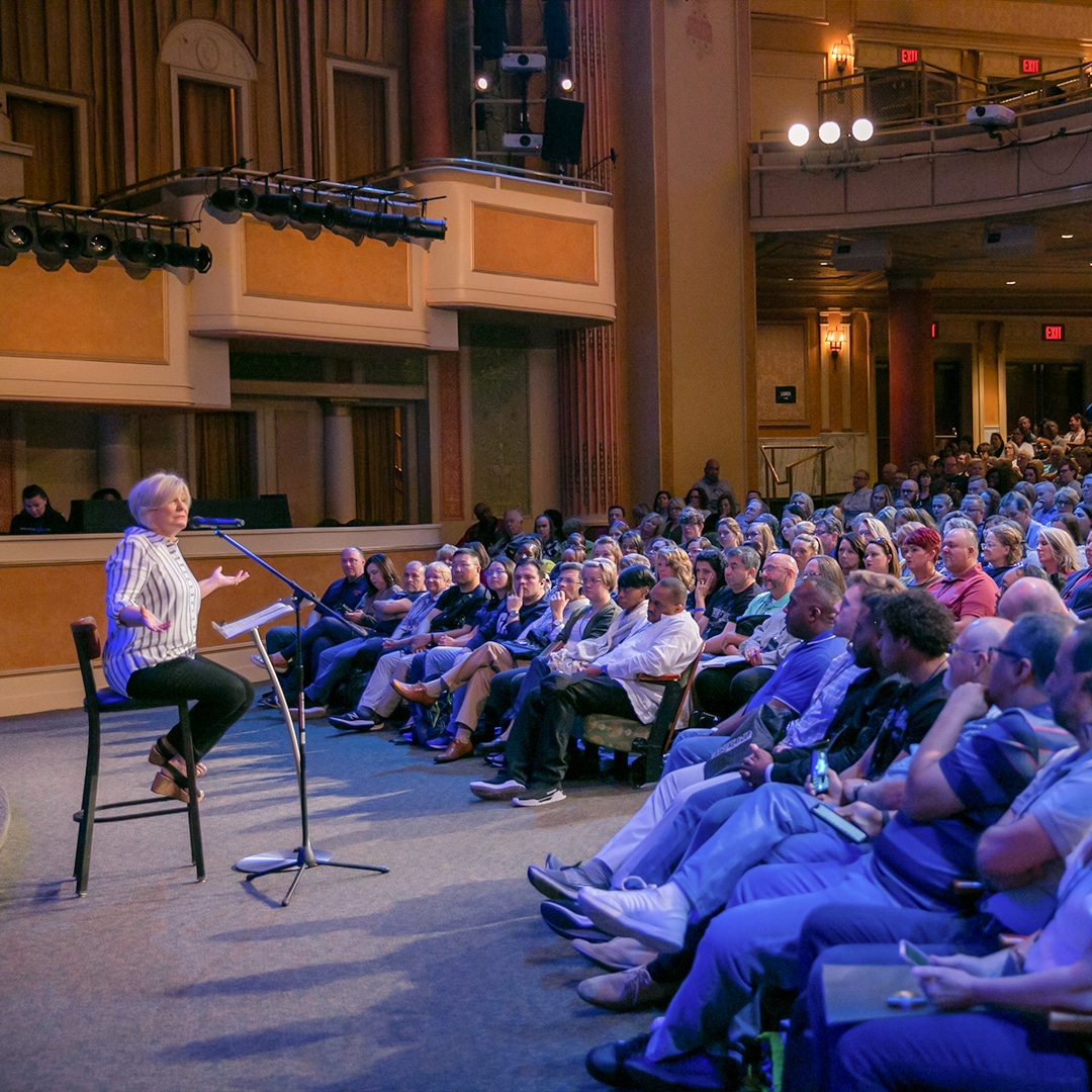 Carol Cymbala speaking in auditorium with conference attendees