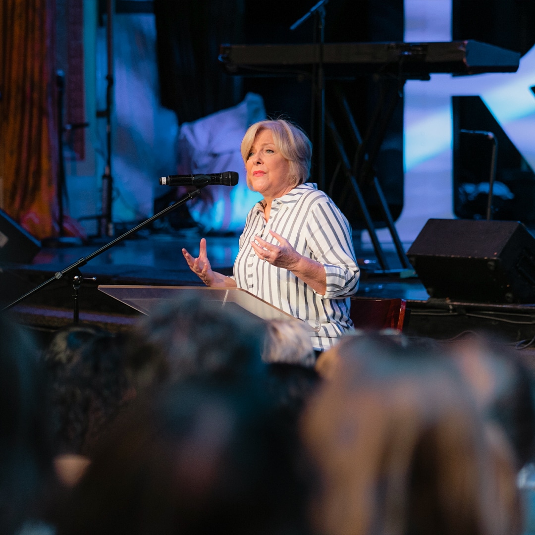 closeup of Carol Cymbala speaking to congregation