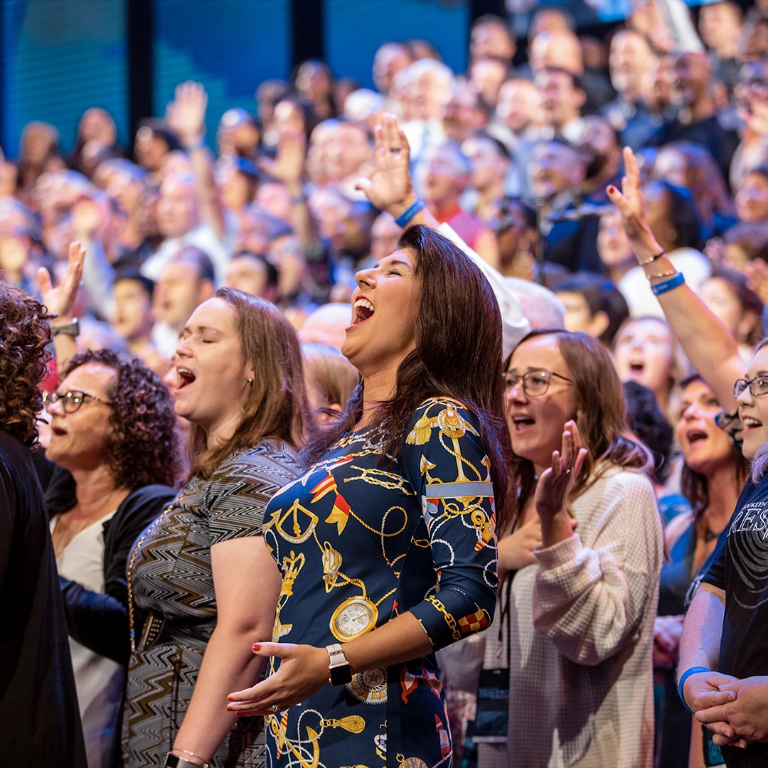 Choir worshipping the Lord joyfully with some hands lifted