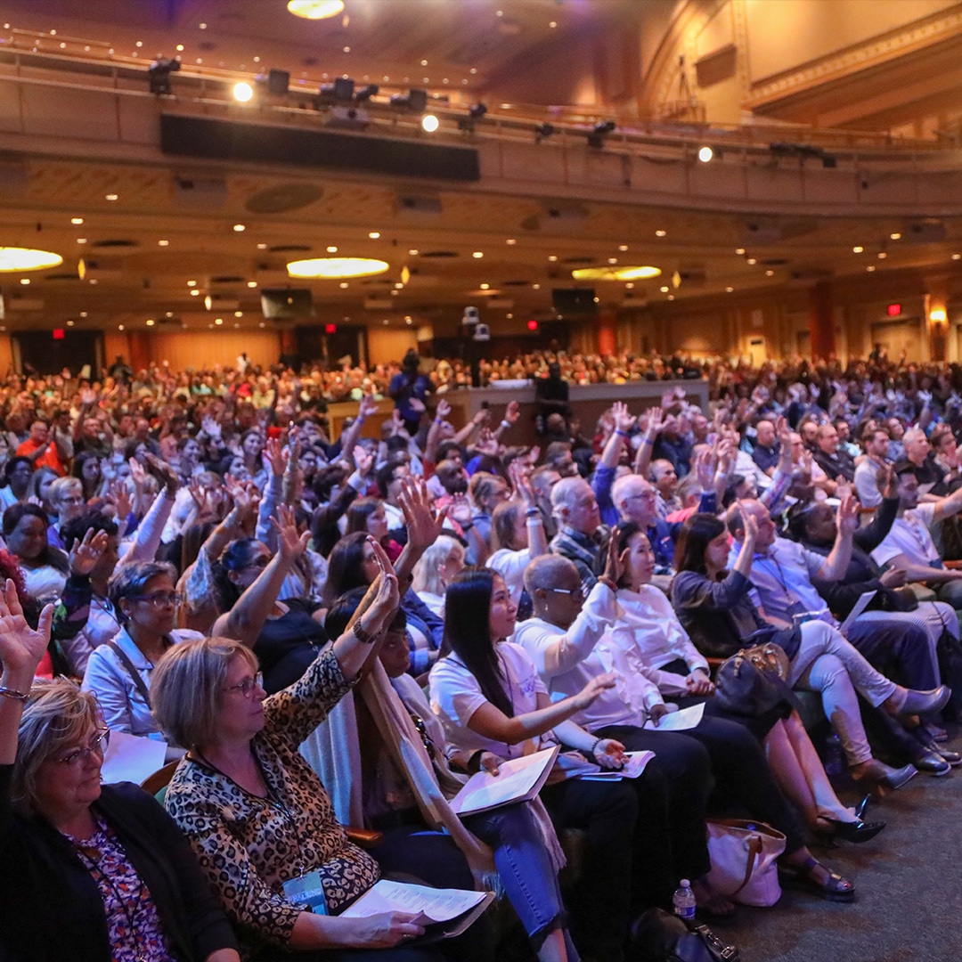 Congregation with lifted hands in sanctuary