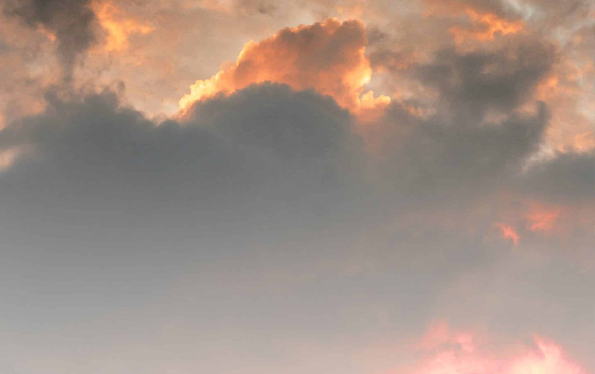 The dark clouds rolling in blocking the sunlight