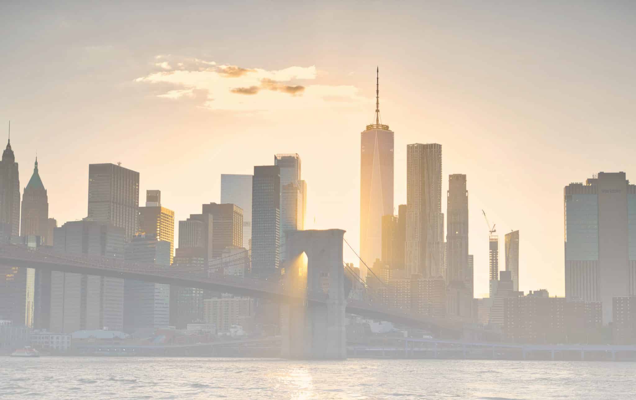 The sun shining behind the New York City skyline.