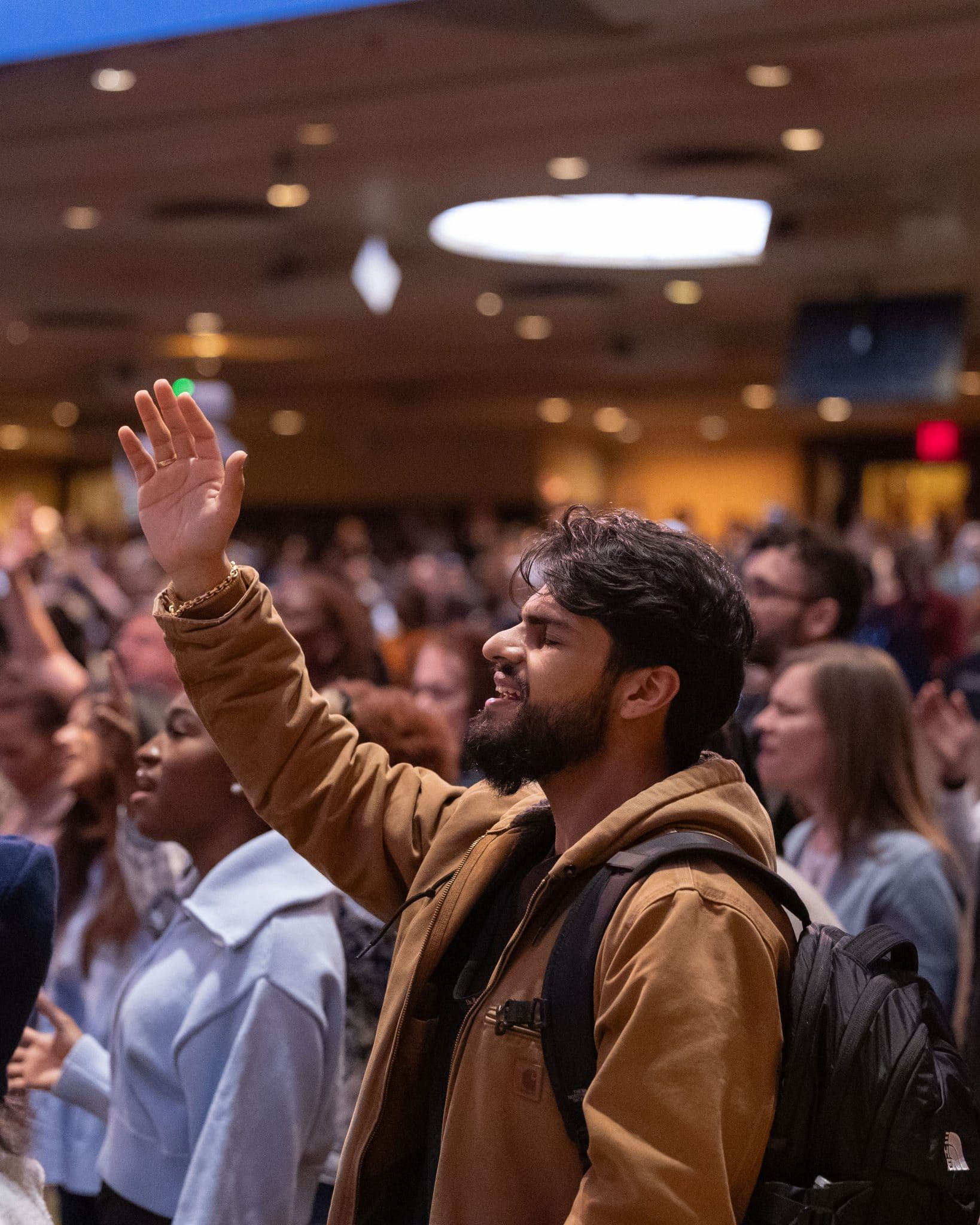 A man worshiping God with hand raised