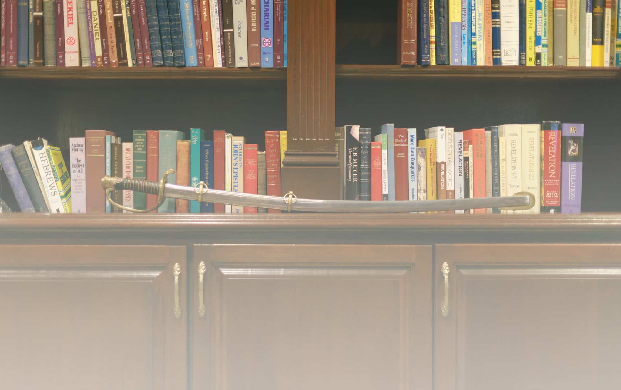 A sword on a bookshelf, symbolizing the armor of God for spiritual warfare