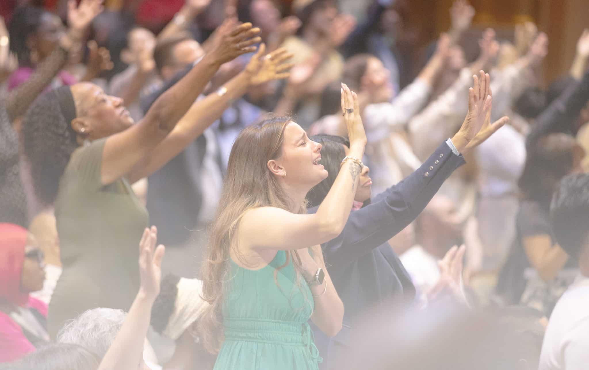 A congregant lifting up Jesus in true worship.