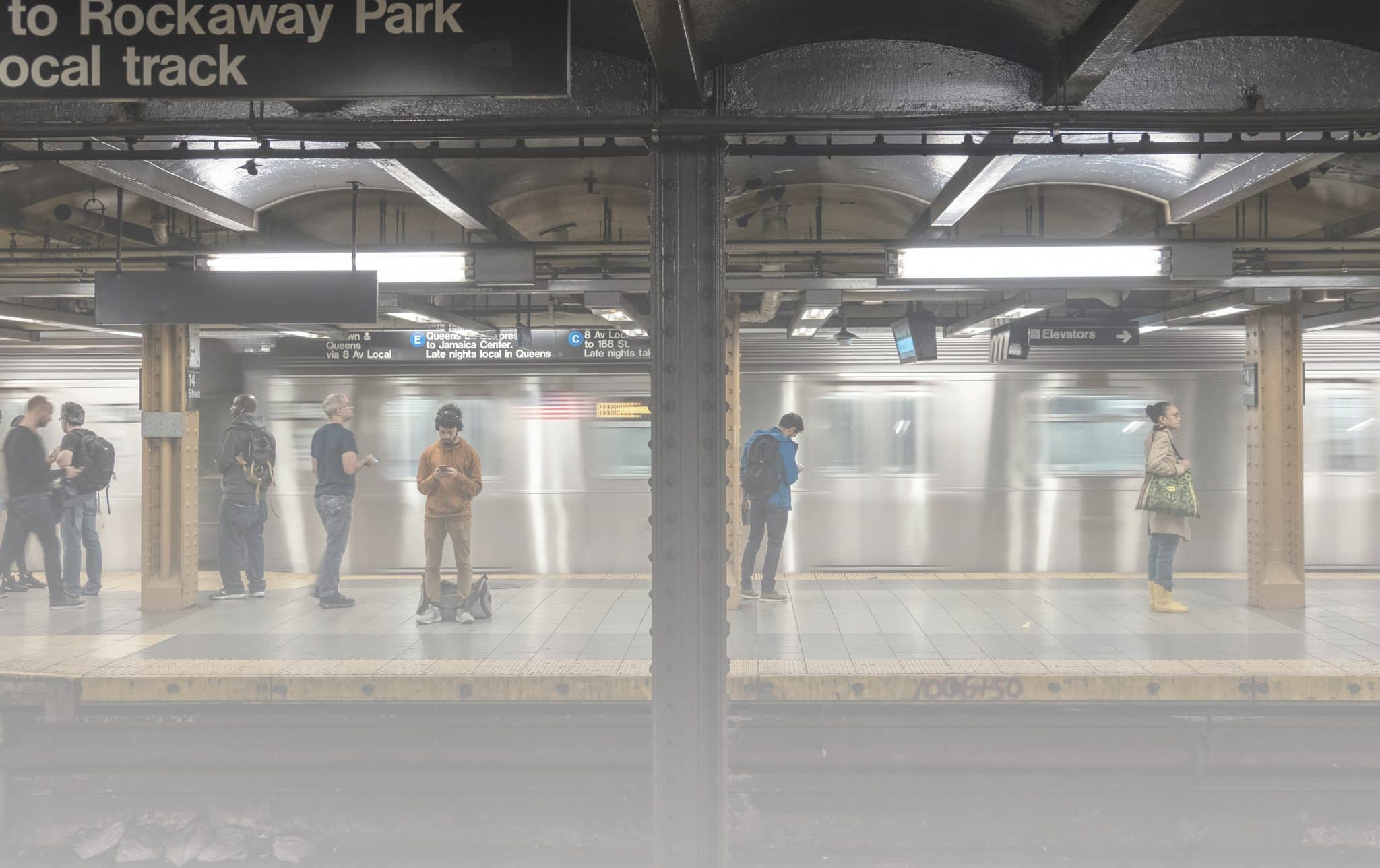 New Yorkers waiting on a subway platform, reflecting God’s plans in the day to day