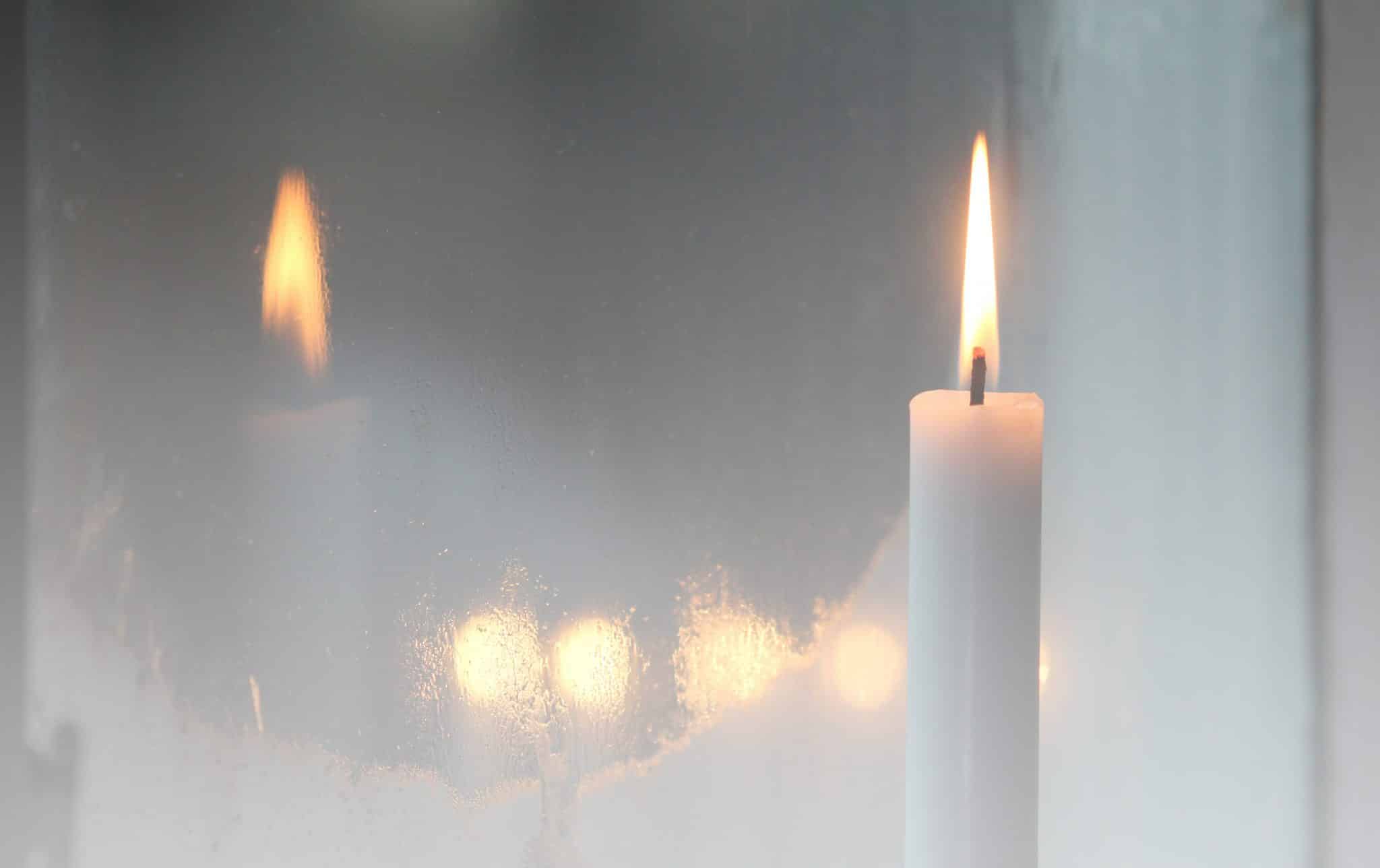 Candlelight shining through a frosted window